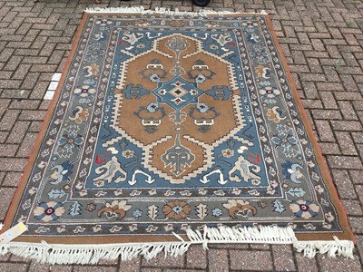 Lot 101 - Eastern rug with geometric decoration on orange and blue ground, measuring 232 x 170cm