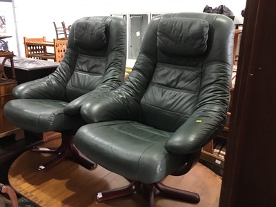 Lot 110 - Pair of Contemporary green leather easy chairs on wooden bases, together with matching foot stools, each chair approx 106cm in height (4)