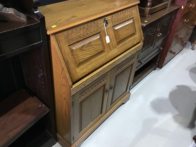 Lot 116 - Golden oak bureau with fall flap and two carved panelled doors below, 85cm in width, 101cm in height, 43cm in depth