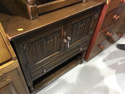 Lot 121 - Old Charm style oak side cupboard, panelled doors with carved linen fold decoration, and draw below with under tier, 78 x 85 x 41cm