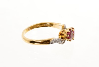 Lot 436 - 18ct gold two ruby cross over stone ring decorated with chip diamonds on flank