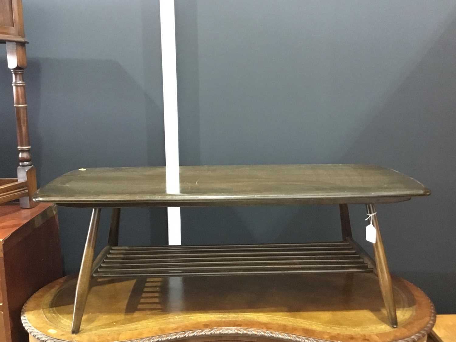 Lot 137 - Ercol dark wood coffee table of rectangular form on four turned legs joined by stretchers, 105 x 37 x 46cm