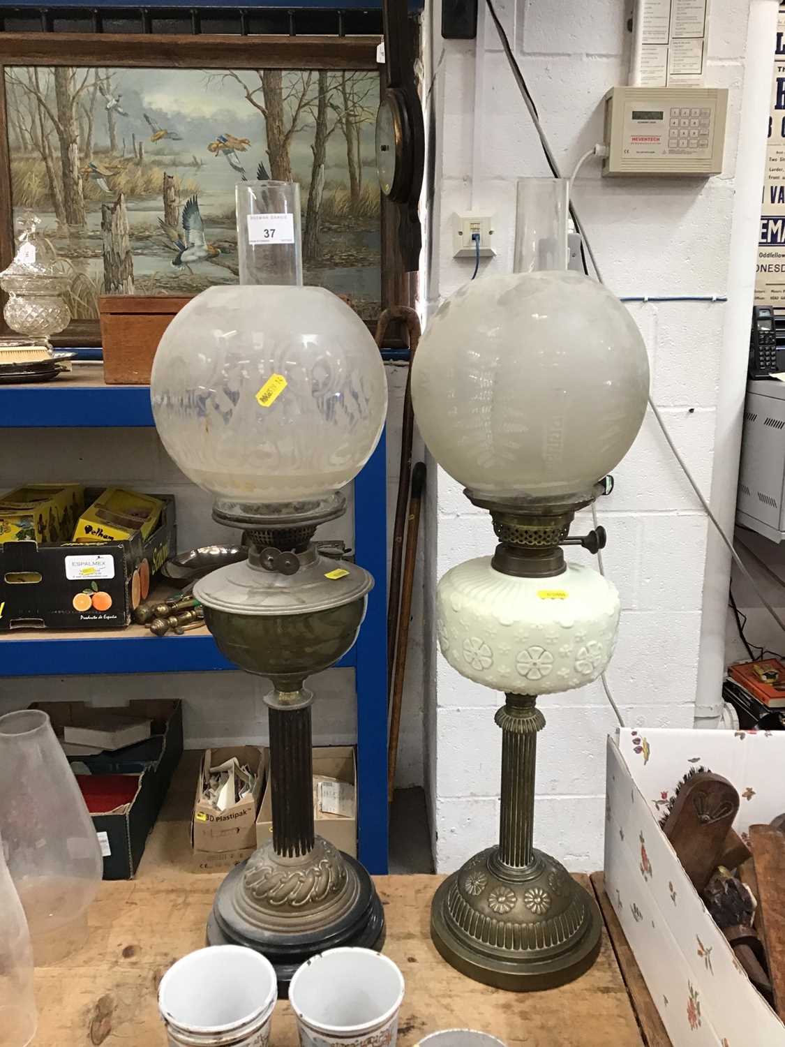 Lot 37 - Two Victorian brass oil lamps, one with a milk glass reservoir (2)