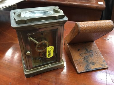 Lot 121 - Brass carriage clock with white enamel dial, together with a brown leather cased travelling clock (2)