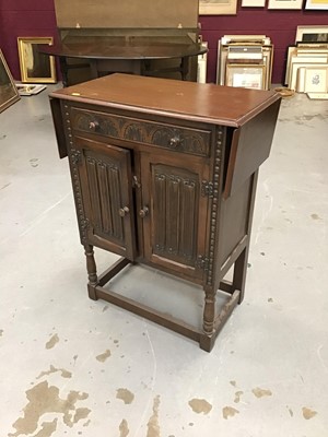 Lot 913 - Old charm style drop leaf side cupboard with carved linen fold decoration