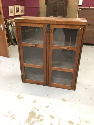 Lot 911 - Stained pine cabinet, enclosed by glazed doors