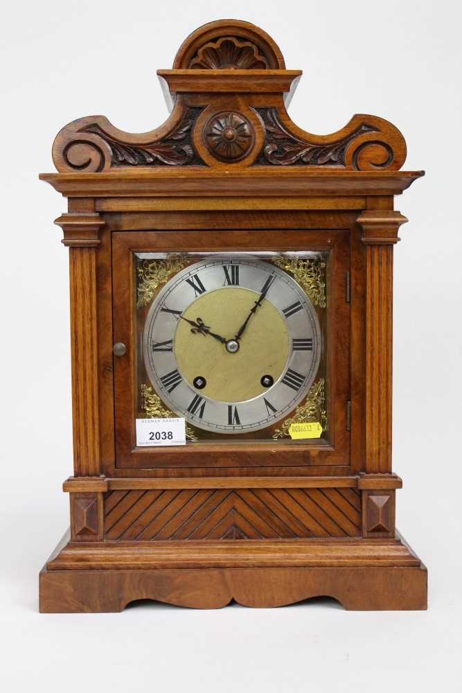 Lot 2038 - Edwardian walnut mantle clock with key and