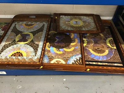 Lot 109 - Four South American wooden trays with butterfly wing decoration (4)