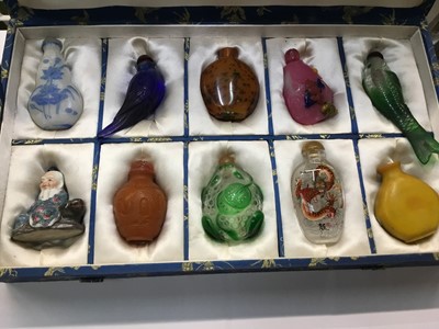 Lot 232 - Collection of ten Chinese snuff bottles in silk covered box