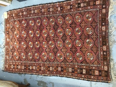 Lot 1007 - Old Bokhara rug with repeating medallion design on reg ground