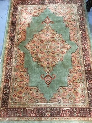 Lot 1009 - Old Persian rug with central medallion on green ground