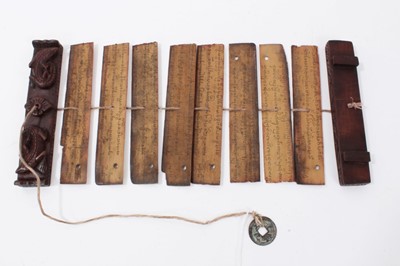 Lot 747 - Antique Tibetan prayers strips with carved hardwood casing