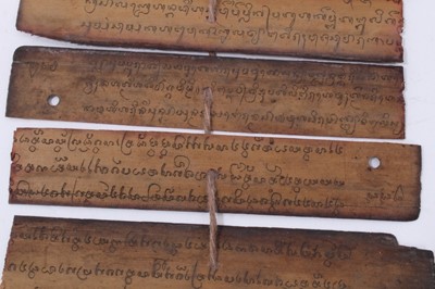 Lot 747 - Antique Tibetan prayers strips with carved hardwood casing