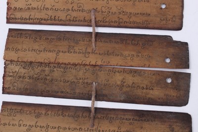 Lot 747 - Antique Tibetan prayers strips with carved hardwood casing