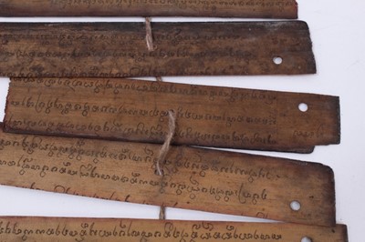 Lot 747 - Antique Tibetan prayers strips with carved hardwood casing