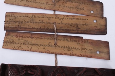 Lot 747 - Antique Tibetan prayers strips with carved hardwood casing