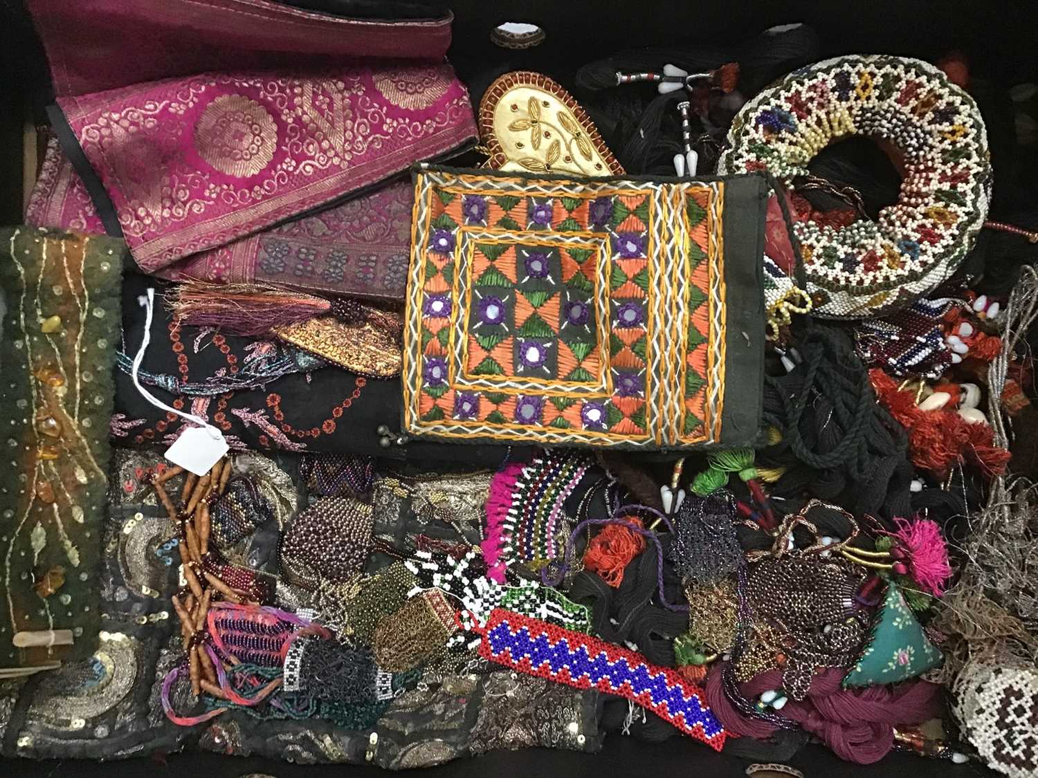 Lot 1808 - Two boxes Eastern fabrics, beaded items,
