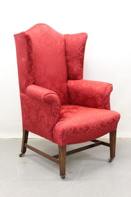 Lot 1250 - 19th century wing armchair on mahogany and brass legs, upholstered in red silk fabric