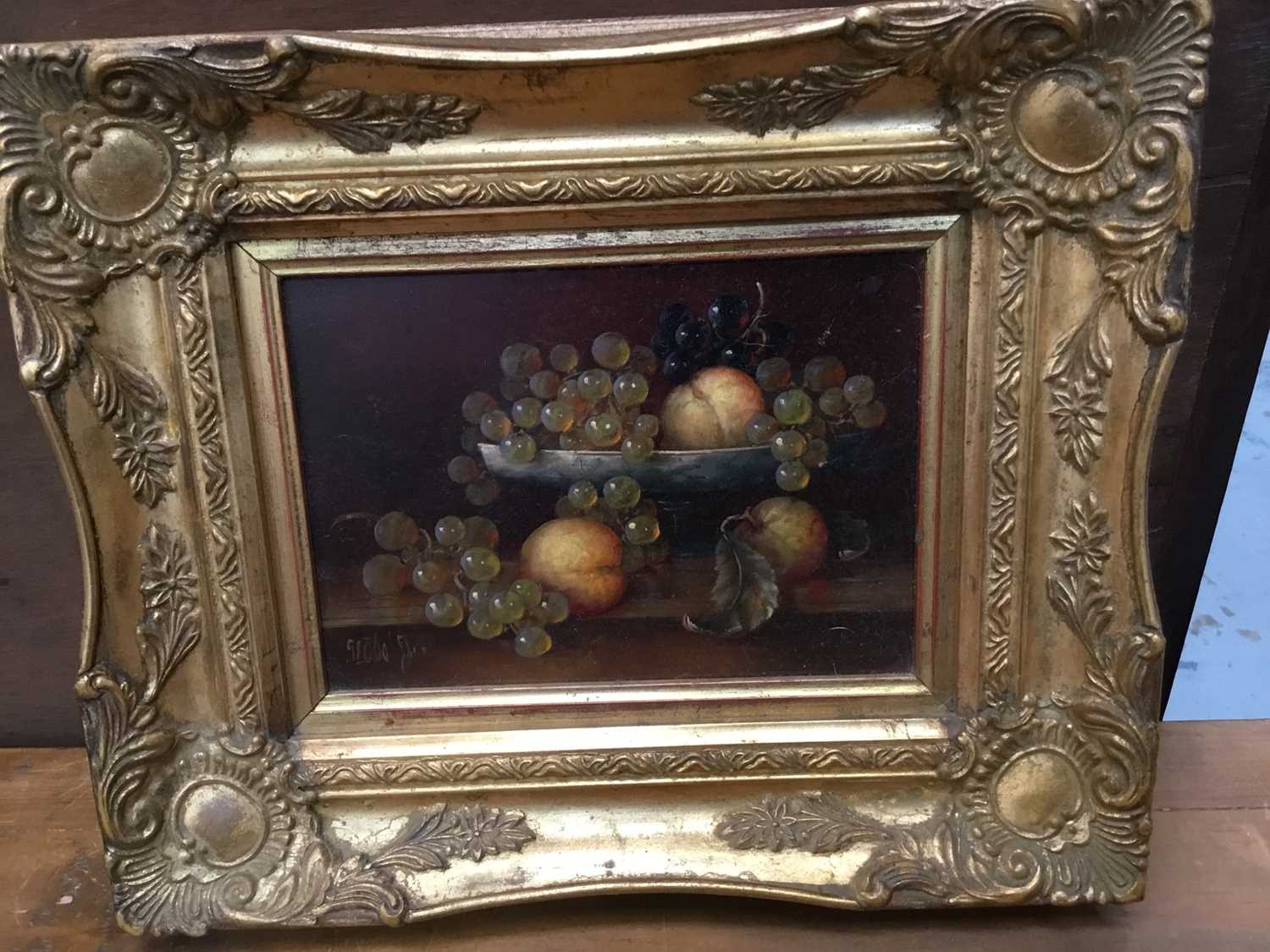 Lot 33 - Pair of Continental school oils on panel - still life of fruit, indistinctly signed, in gilt frames