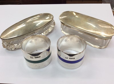 Lot 658 - Two silver topped cut glass vanity jars and two silver and enamelled napkin rings