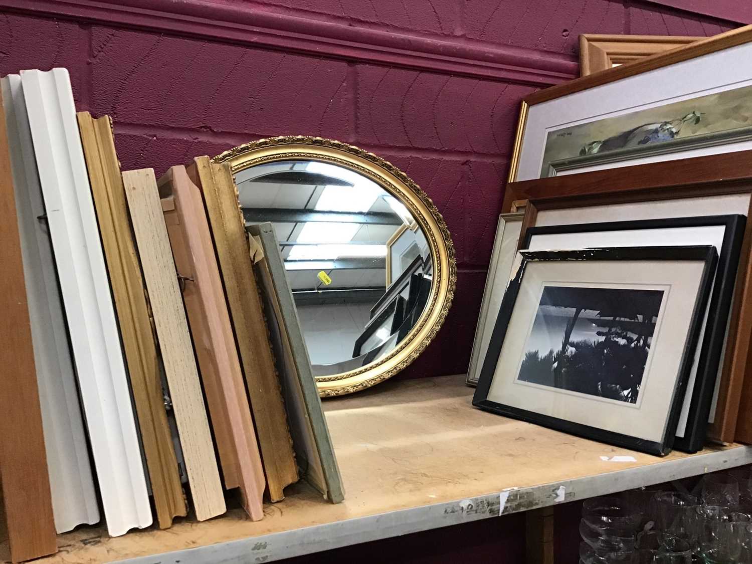 Lot 521 - Bevelled edge oval mirror in guilt frame and pictures