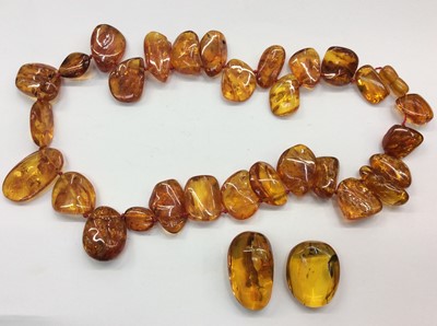 Lot 667 - Amber bead necklace and two other pieces of amber