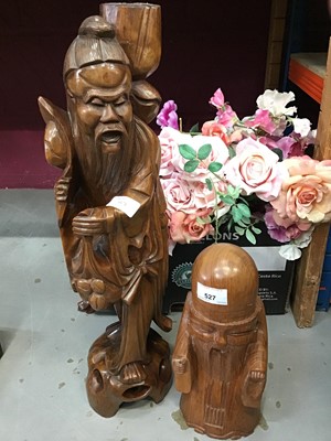 Lot 527 - Two oriental carved wooden figures and artificial roses