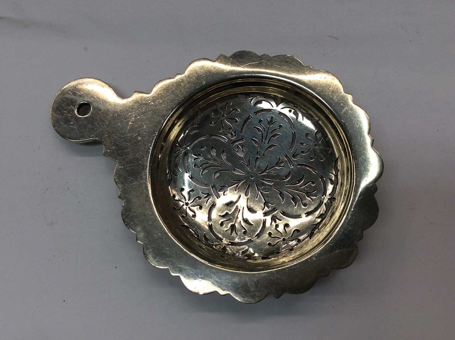 Lot 679 - Silver tea strainer