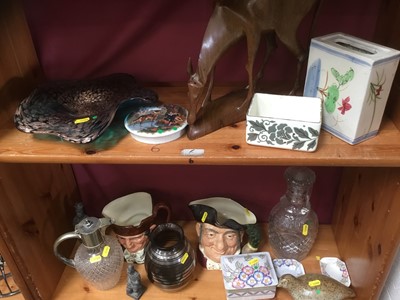 Lot 159 - Decorative ceramics and glass including silver plated claret jug, two Doulton character jugs, Charlotte Rhead ceramics, carved African figure of an antelope, art glass dish, decanter and other item...