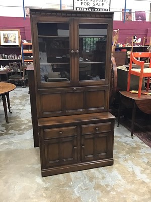 Lot 893 - Ercol two height unit with glazed doors, fall flap, drawers and cupboards below and another similar (2)