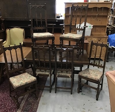 Lot 895 - Ercol draw leaf dining table and a set of six matching chairs