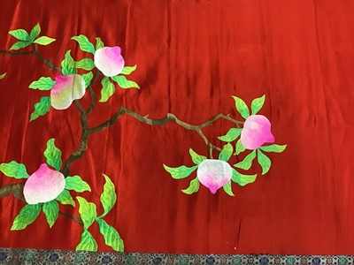 Lot 1769 - Large Chinese embroidered red silk hanging.  Bright polychrome silk thread embroidered woman with deer under peach tree.  Brocade edging and pink cotton backing. On a wood baton. length 250cm appro...