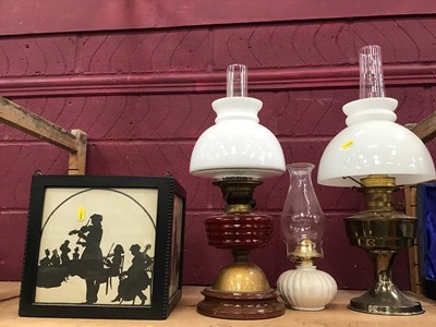 Lot 546 - Three oil lamps and box shade with musician silhouettes