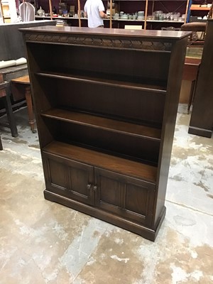 Lot 973 - Pair of Ercol open bookcases cupboards below