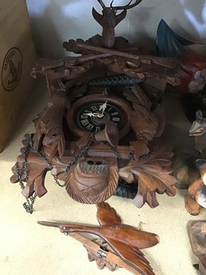 Lot 219 - Collection of carved wooden figures and ornaments, and a Black Forest clock