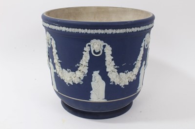 Lot 46 - Large antique Wedgwood dark blue jasper ware jardinière, circa 1890, decorated with classical figures and swags, marks to base, 23cm height x 26cm diameter