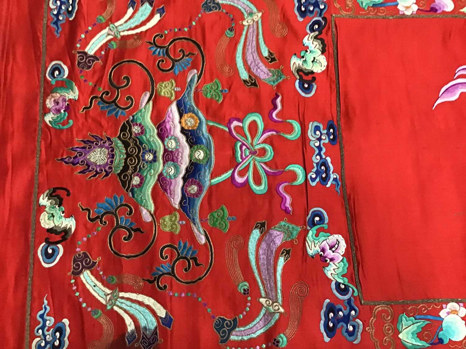 Lot 1777 - Large Chinese embroidered red silk wall hanging. Polychrome silk thread embroidered colourful cockerel, lotus flowers, other flowers, insects, clouds and symbols. Pink cotton backing and wood rod f...