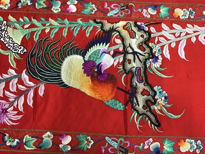 Lot 1777 - Large Chinese embroidered red silk wall hanging. Polychrome silk thread embroidered colourful cockerel, lotus flowers, other flowers, insects, clouds and symbols. Pink cotton backing and wood rod f...