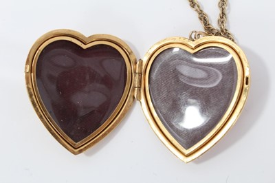 Lot 19 - 9ct gold large heart shaped locket on a yellow metal chain