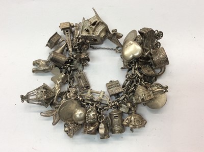 Lot 683 - Silver charm bracelet with large quantity of silver and white metal novelty charms