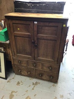 Lot 1047 - Georgian pine cupboard with shelved interior enclosed by two panelled doors with an arrangement of five drawers below