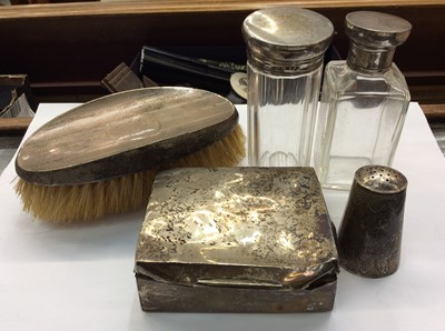 Lot 693 - Two silver topped glass bottles, silver backed hairbrush, silver cigarette box and white metal pepperette