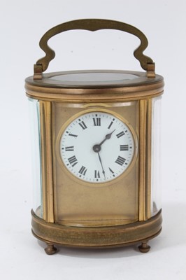 Lot 607 - Antique oval carriage clock with circular dial