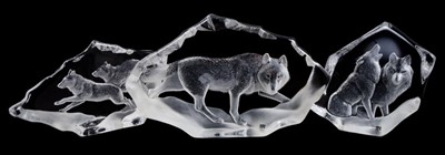 Lot 861 - Mats Jonasson glass sculpture - Timber Wolf (27010) signed and numbered 35/975, 30cm long, together with two further Mats Jonasson sculptures of wolf subjects. (3)