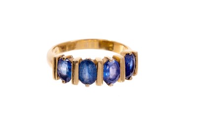 Lot 466 - Sapphire four stone ring with four oval mixed cut blue sapphires measuring approximately 6.5-6.7mm x 4.5mm in 18ct gold setting.