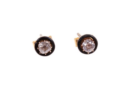 Lot 467 - Pair of diamond and black enamel earrings, each with an old cut diamond in claw setting within a circular black enamel border. Estimated total diamond weight approximately 0.60cts