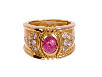 Lot 485 - Red stone, gold and diamond ring with an oval cabochon red stone flanked by twelve brilliant cut diamonds