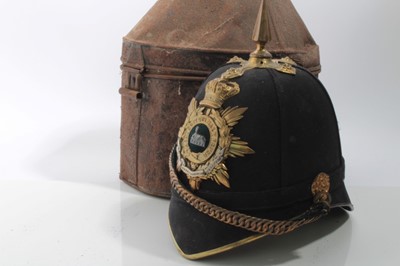 Lot 635 - Victorian Lincolnshire Regiment Officers' Blue Cloth helmet with bi metal regimental badge, brass spike and fittings, brass chin chains and leather head band, in japanned tin transit case