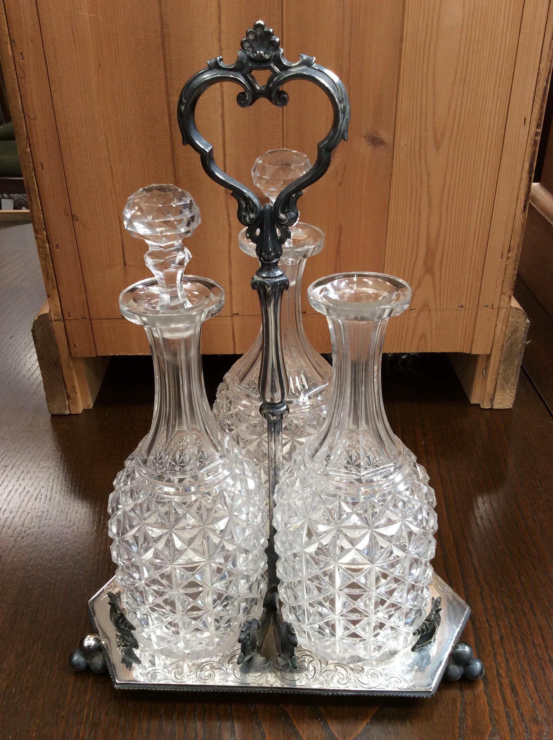 Lot 439 Silver plated three bottle decanter stand