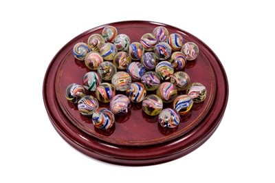 Lot 665 - Antique solitaire board housing thirty-three very large antique multi twist marbles